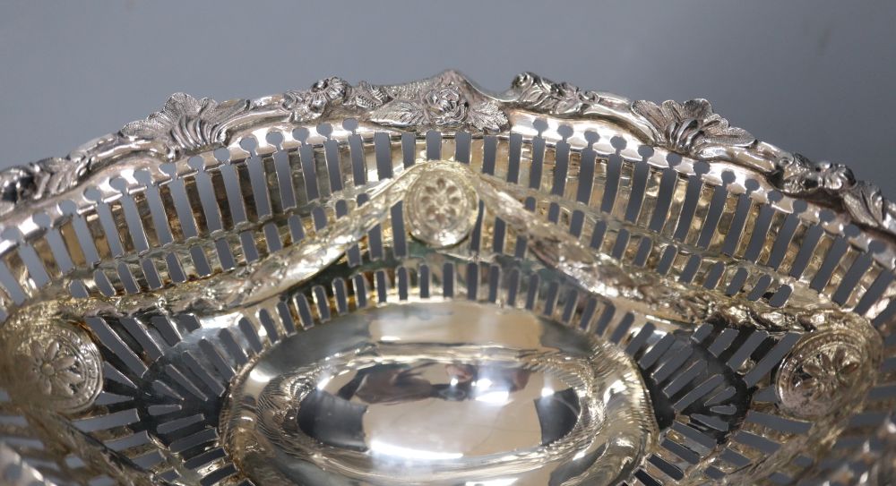 A pair Victorian pierced and cast silver oval bon bon dishes, London 1895, maker Thomas Bradbury, 19.2cm, 11oz.